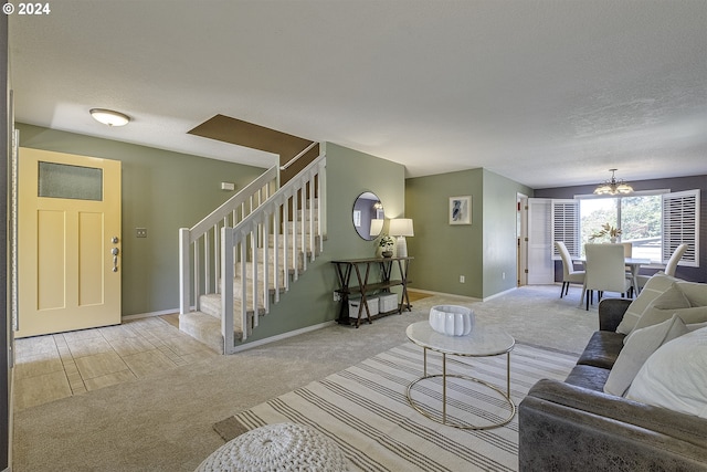 living room with light carpet, a textured ceiling, and a notable chandelier