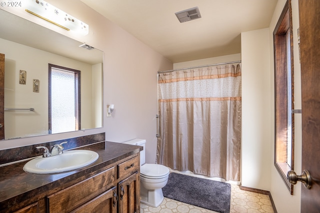 bathroom with vanity, toilet, and a shower with curtain