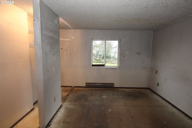 spare room with a textured ceiling