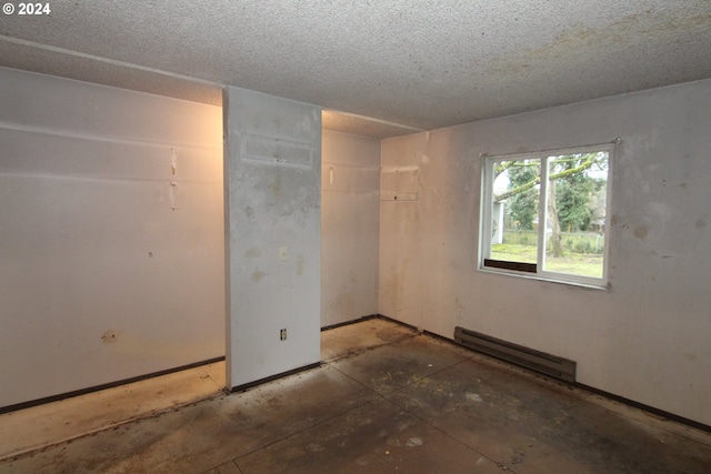 interior space featuring a textured ceiling and a baseboard radiator