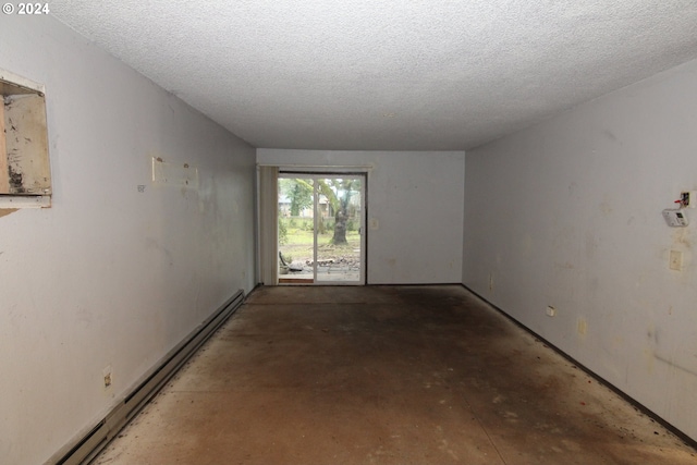 empty room with a textured ceiling and a baseboard heating unit