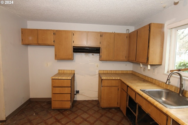 kitchen featuring sink and a textured ceiling