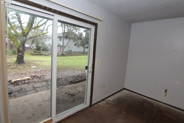 doorway with a textured ceiling