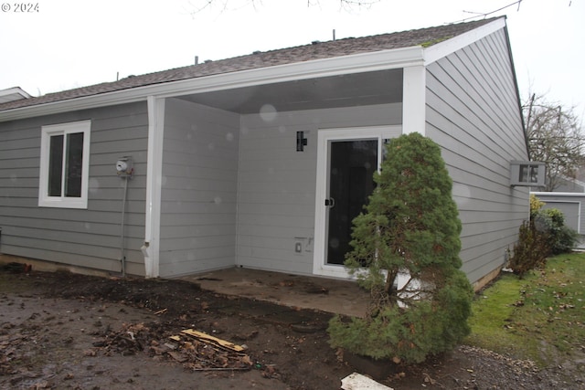 view of exterior entry with a patio