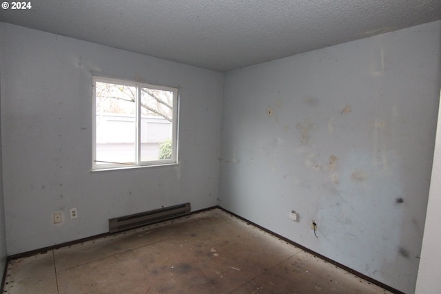 unfurnished room with a baseboard radiator and a textured ceiling