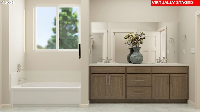 bathroom featuring a washtub and vanity