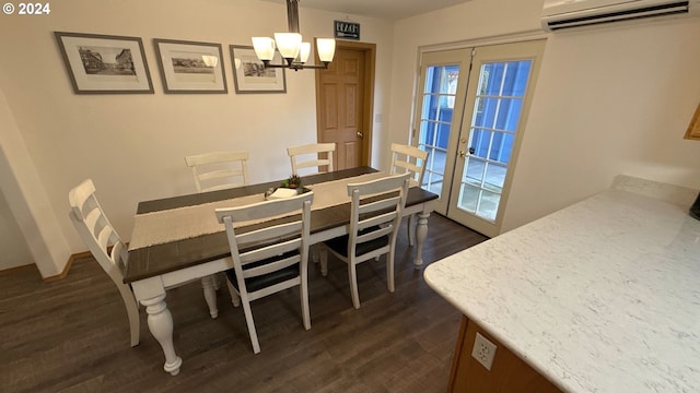 dining space with a wall mounted air conditioner, dark hardwood / wood-style floors, french doors, and a chandelier