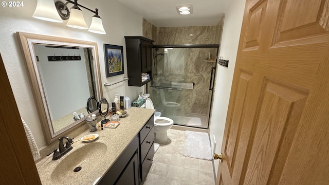 bathroom featuring tile patterned floors, toilet, an enclosed shower, and vanity