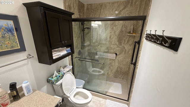 bathroom with a shower with door and toilet