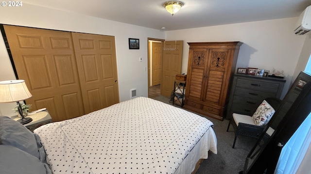 carpeted bedroom with a wall unit AC and a closet