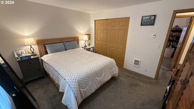 bedroom featuring a closet and dark colored carpet