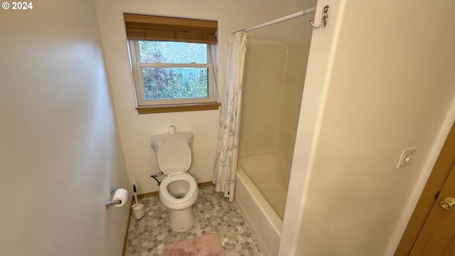 bathroom featuring tile patterned flooring, shower / tub combo with curtain, and toilet