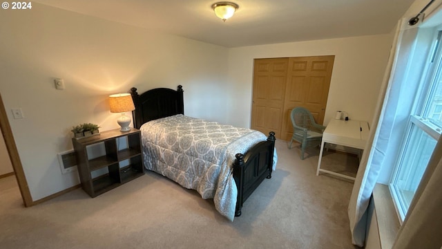 carpeted bedroom featuring multiple windows and a closet