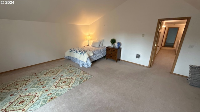 carpeted bedroom featuring lofted ceiling