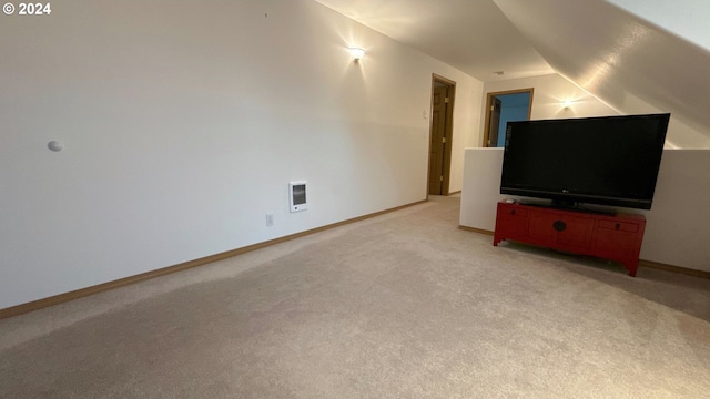 unfurnished living room featuring light carpet and vaulted ceiling