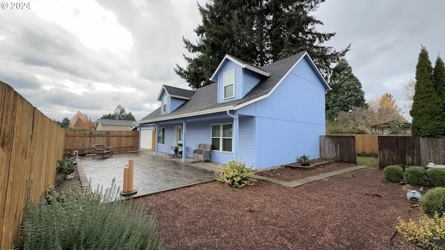 rear view of house with a patio and an outdoor fire pit