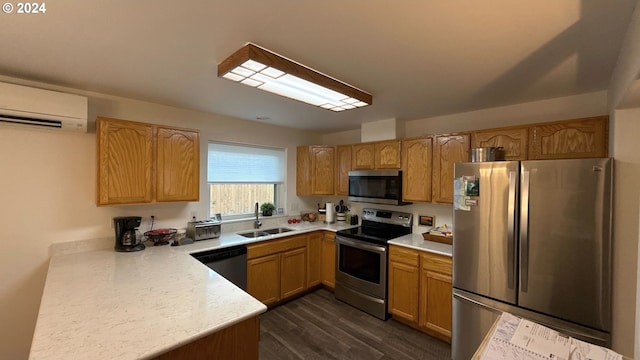 kitchen with an AC wall unit, dark hardwood / wood-style flooring, sink, and appliances with stainless steel finishes