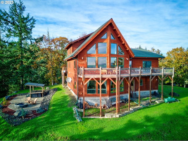 back of property featuring a balcony, a yard, and a patio