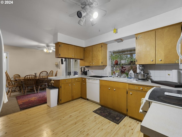 kitchen with dishwasher, sink, backsplash, and light hardwood / wood-style flooring