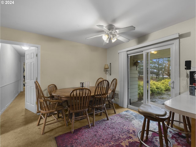 carpeted dining space featuring ceiling fan