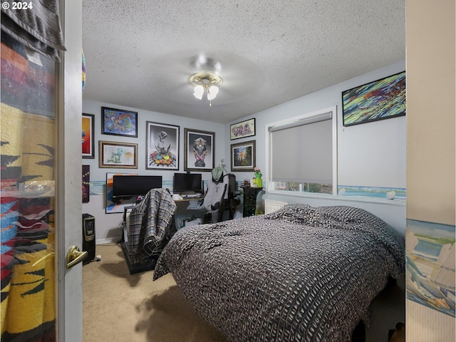 bedroom with carpet flooring, ceiling fan, and a textured ceiling