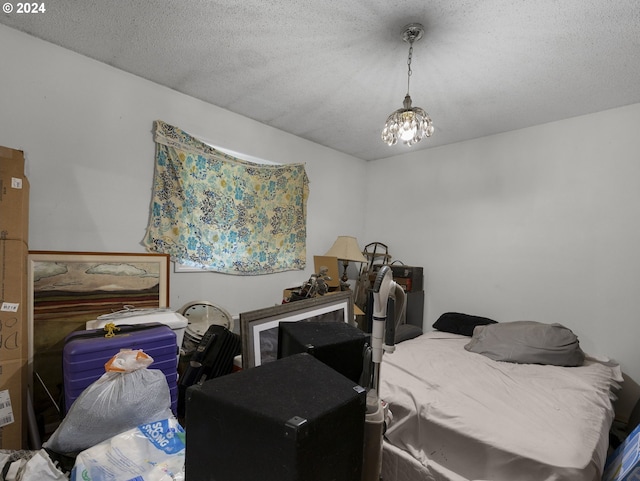 bedroom with a textured ceiling and an inviting chandelier