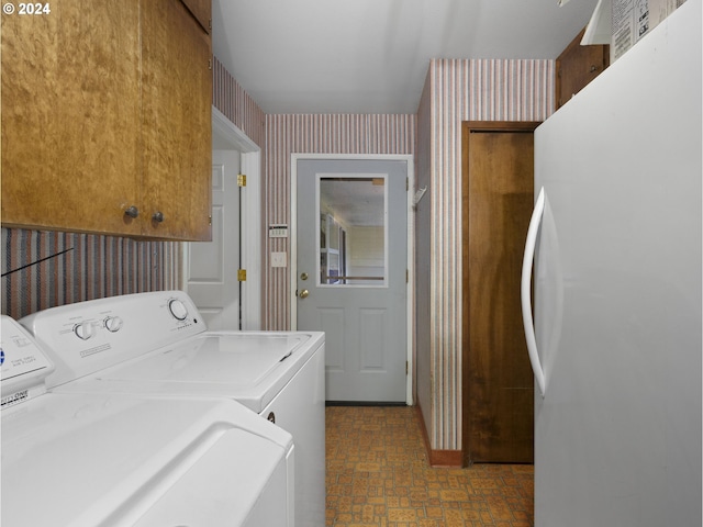 15600 SE Orient Dr, Boring, OR 97009 - laundry room featuring wallpapered walls, independent washer and dryer, brick patterned floors, and cabinet space