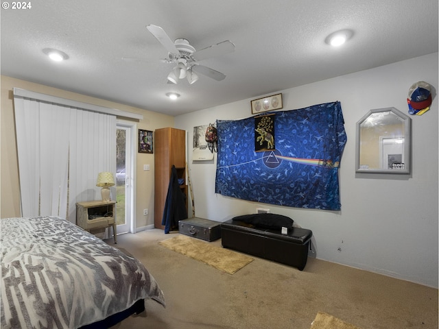 bedroom with carpet, ceiling fan, and a textured ceiling