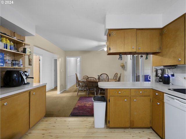 kitchen featuring kitchen peninsula, decorative backsplash, white dishwasher, ceiling fan, and light hardwood / wood-style floors