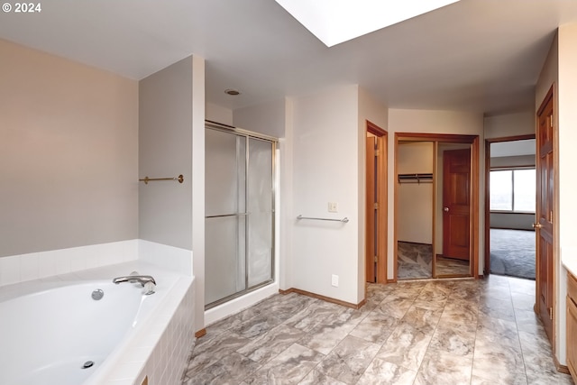 bathroom featuring shower with separate bathtub