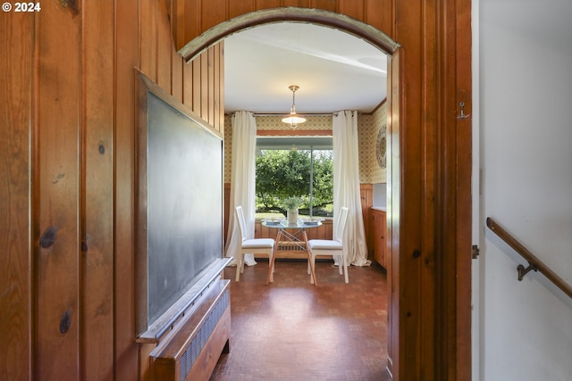 hall with radiator and wooden walls