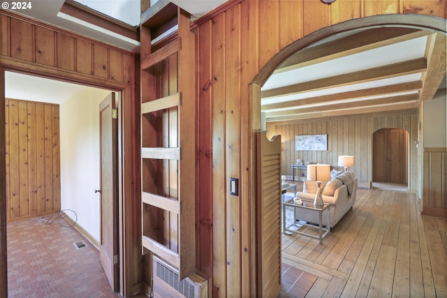 hall featuring wooden walls and hardwood / wood-style flooring