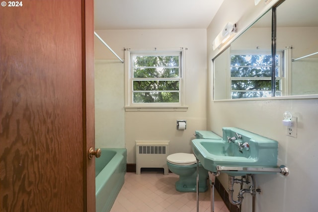 bathroom featuring radiator heating unit, toilet, tile patterned floors, and sink