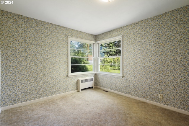 spare room featuring radiator heating unit