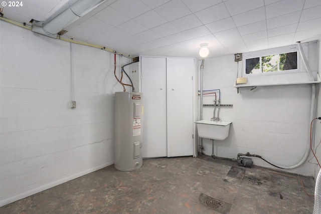 basement with electric water heater and sink