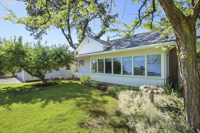 view of side of property with a lawn