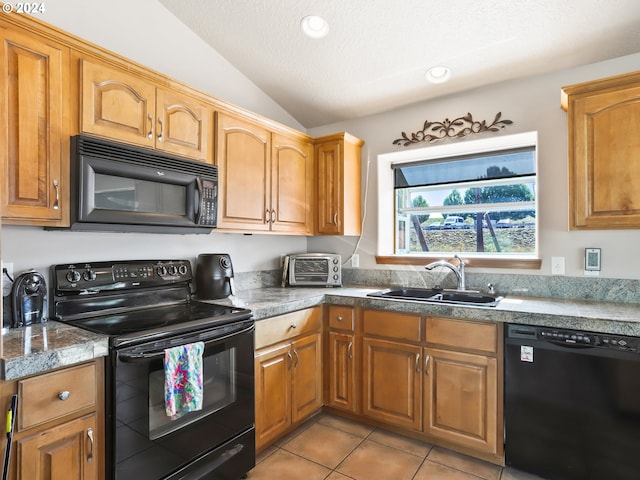 kitchen with light tile patterned flooring, vaulted ceiling, a textured ceiling, black appliances, and sink