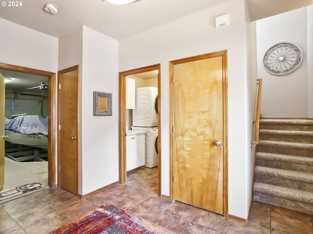 interior space with a closet, stacked washer / dryer, and ensuite bathroom