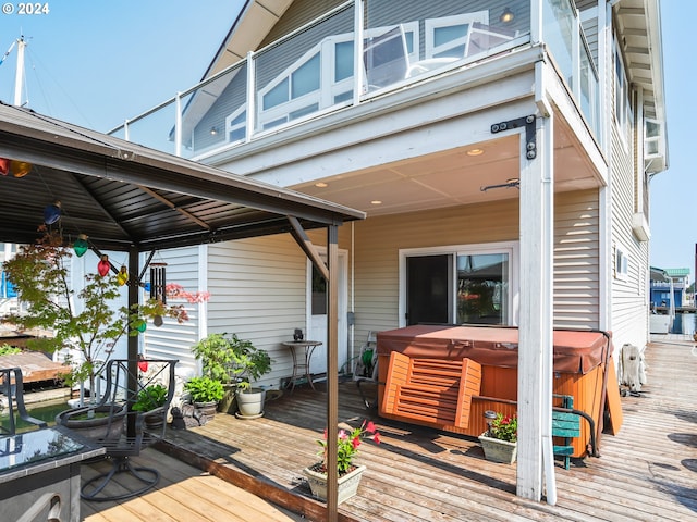 wooden deck featuring a hot tub