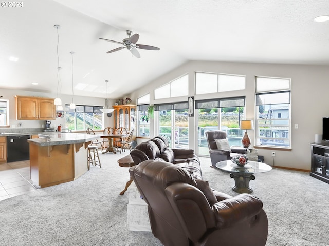 carpeted living room with a healthy amount of sunlight, lofted ceiling, and ceiling fan