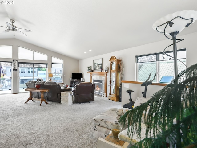 carpeted living room with lofted ceiling and ceiling fan