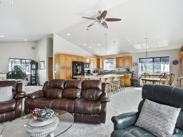 carpeted living room featuring high vaulted ceiling, ceiling fan, a healthy amount of sunlight, and sink