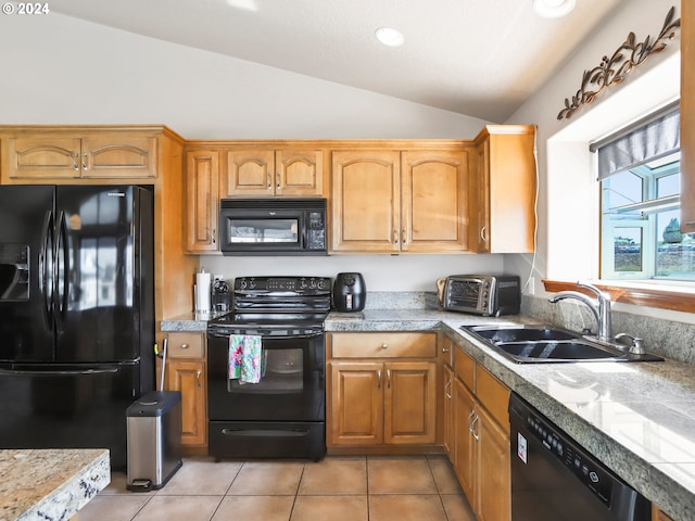 kitchen with light tile patterned flooring, lofted ceiling, sink, and black appliances