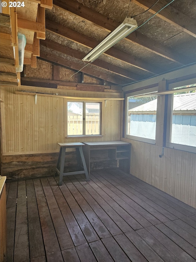 miscellaneous room with wood walls, hardwood / wood-style flooring, and vaulted ceiling with beams