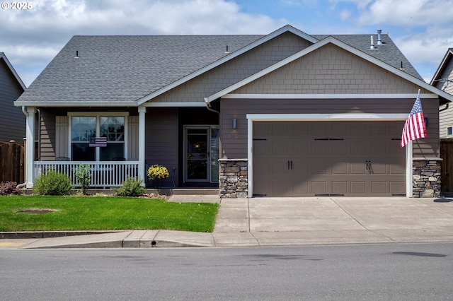 1008 S 41st St, Springfield, OR 97478 - craftsman-style house featuring a garage, roof with shingles, driveway, covered porch, and stone siding