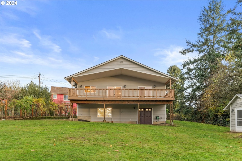 rear view of property with a yard and a deck