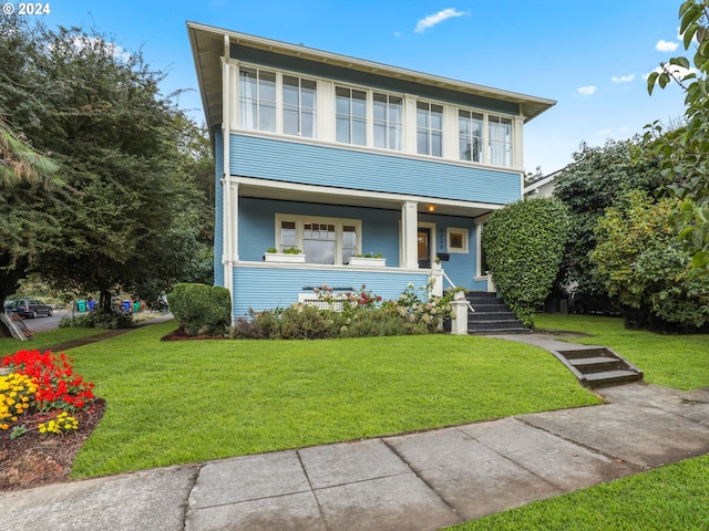 view of front facade featuring a porch and a front lawn