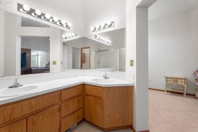 bathroom with vanity and a shower with door