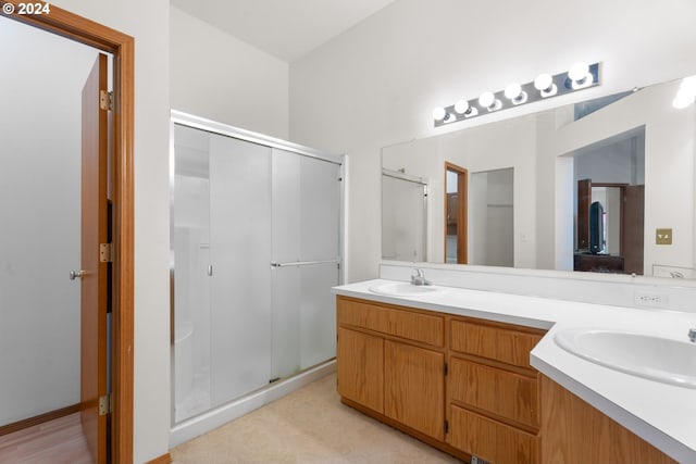 bathroom with walk in shower and vanity