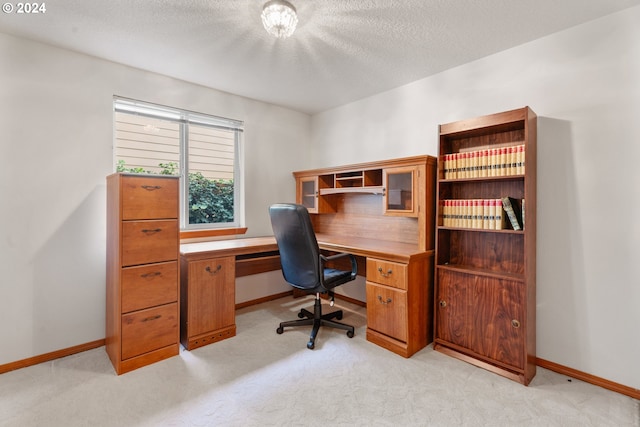 carpeted office space featuring a textured ceiling